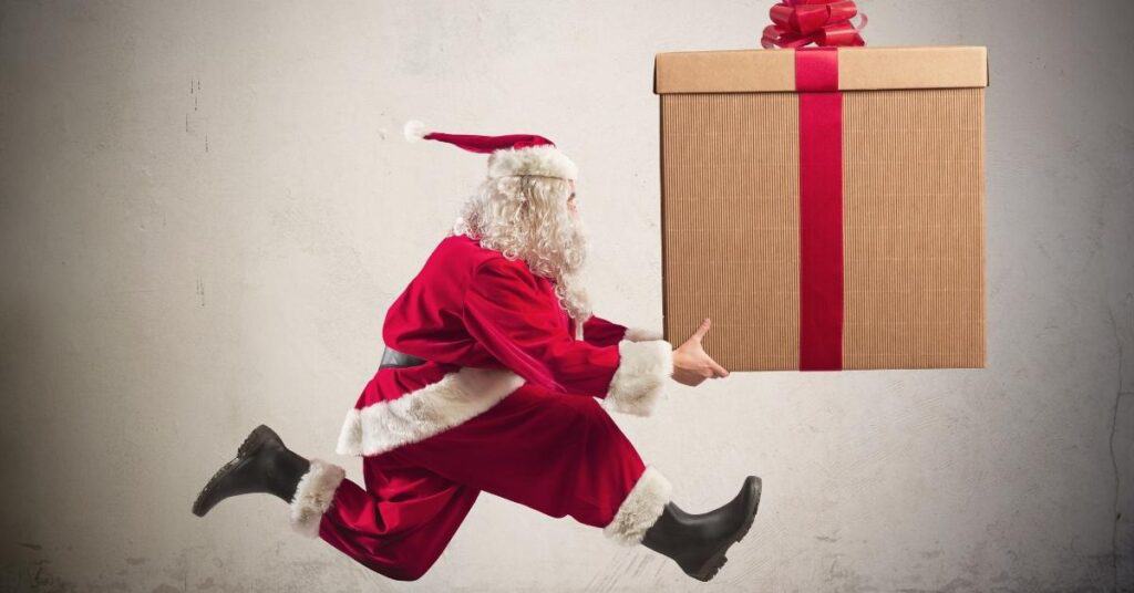 running santa holding a gift package